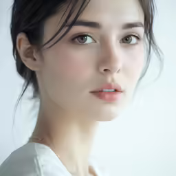 a woman with very short hair and brown eyes is looking to the side