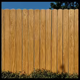 a skateboard on the ground with a fence in the background