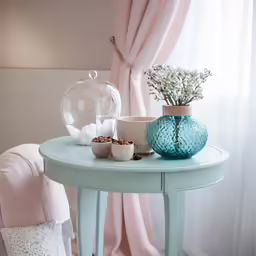 there is a blue vase on a table