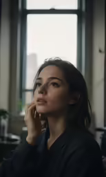 a woman wearing black talking on a cell phone