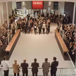 a group of people standing in front of a mall lobby