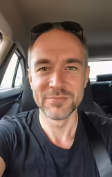 a person is taking a selfie in the car