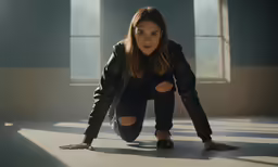 an attractive young woman kneeling on the ground