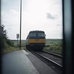 a large yellow train on a steel track