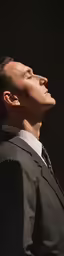 a man standing looking upward with his eyes closed