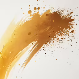 a yellow and orange liquid splatkled on a white background