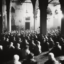 a crowd of people sit around tables inside a building