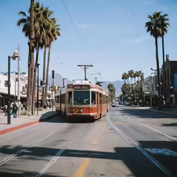 an orange trolley car passing by on the street