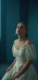 a beautiful young woman in a white dress