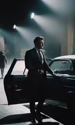 a man in a business suit is standing next to his car