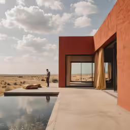 a man standing next to a water pool in the desert