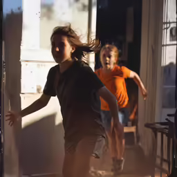 two small children running down a hall way