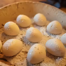 eggs being cooked in a large metal bowl