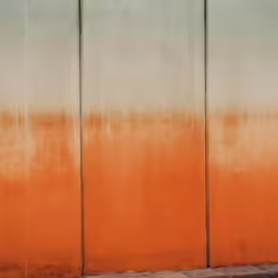 a woman is walking down the sidewalk carrying her luggage