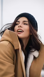 a woman smiles with her head tilted back