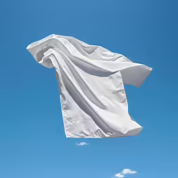 white sheet on a sunny blue sky waving in the wind