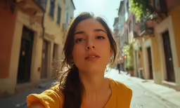 the woman is in a yellow shirt on the street