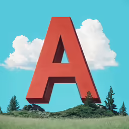 a large red letter sitting on top of a green hill