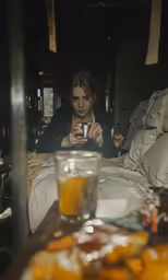 a person is sitting in bed taking a photo