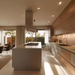 a clean kitchen with an island countertop and chairs