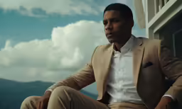 a man is sitting in front of a window