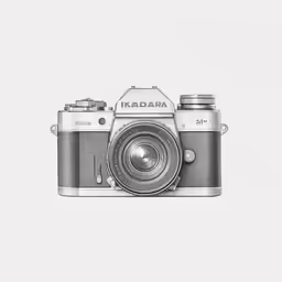 a camera on a white surface with the words, in front