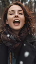 a woman is laughing while outside in the snow