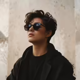 a woman with sunglasses on sitting outside