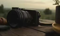 a camera with a large lens sitting on a table