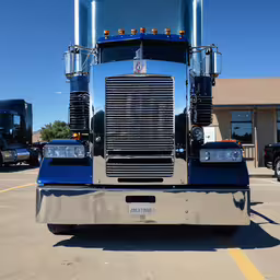 there is a large semi truck parked in the parking lot,the back end of a big truck parked in a parking lot