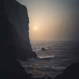 the sun is seen between two large cliffs