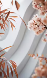 a large white circular structure with white and pink flowers