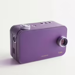 an analog camera on a white surface