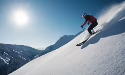 a skier skiing down a slope in the mountains