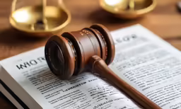 a wooden gaven on top of a book on a table