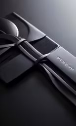 an image of a knife with metal handles on black table