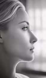 the side view of a woman in black and white with the sun shining through