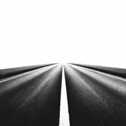 an empty highway with three white lines on the road