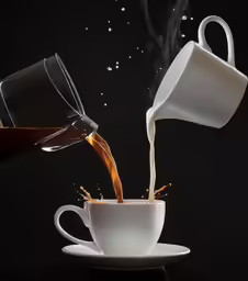 a coffee cup being poured into another coffee cup