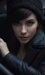 a woman in a black jacket and hat