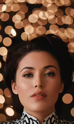 a woman standing in front of a christmas light