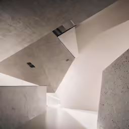 a modern hallway with a skylight and concrete floor
