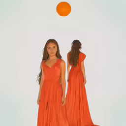 the two young girls are dressed in long orange dresses