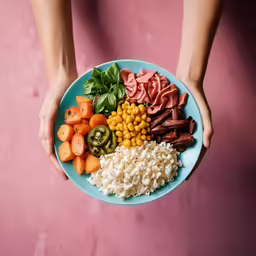 a blue plate holding a meat, vegetable and rice bowl