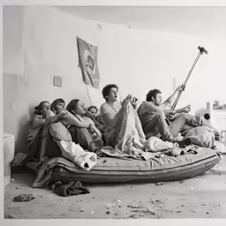 four people lying on the floor in a bed