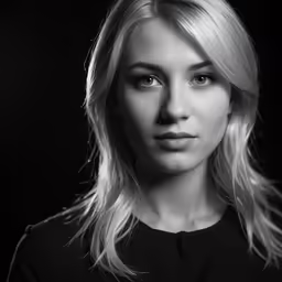 a woman in a black top is looking to her left