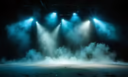 an image of smoke billowing out of the stage