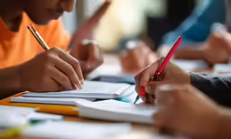 the three students are doing exercises on their work