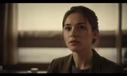 a beautiful woman standing in front of a window with a concerned look
