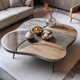 a white and brown coffee table with two chairs